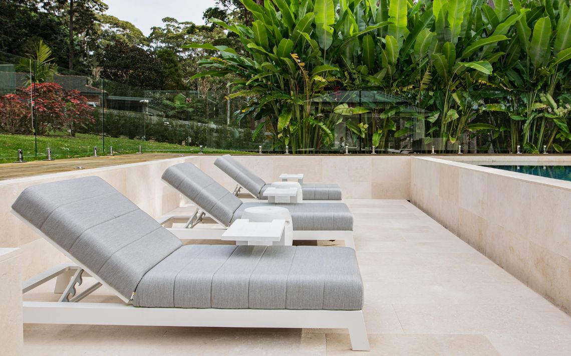 A Piha lounger stone design around by elegance stone with a pool in the right corner.